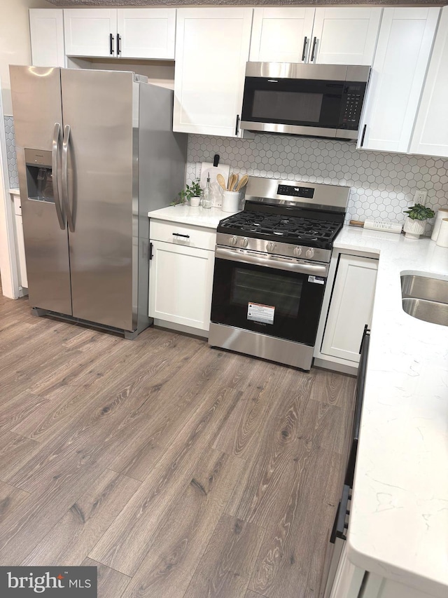 3502 Blue Coat Rd, Baltimore, MD 21236 - kitchen featuring appliances with stainless steel finishes, wood finished floors, and white cabinets