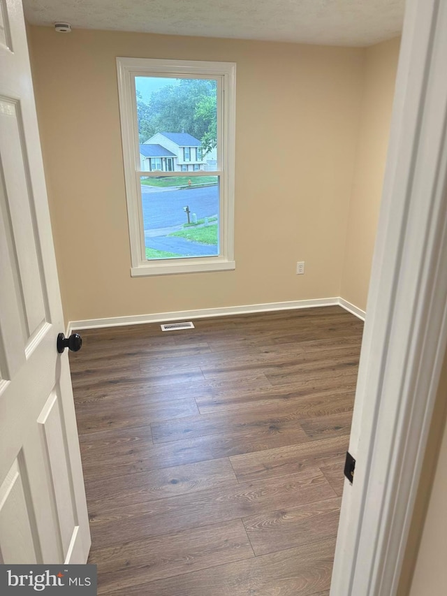 3502 Blue Coat Rd, Baltimore, MD 21236 - empty room with dark wood-style flooring and a smoke detector