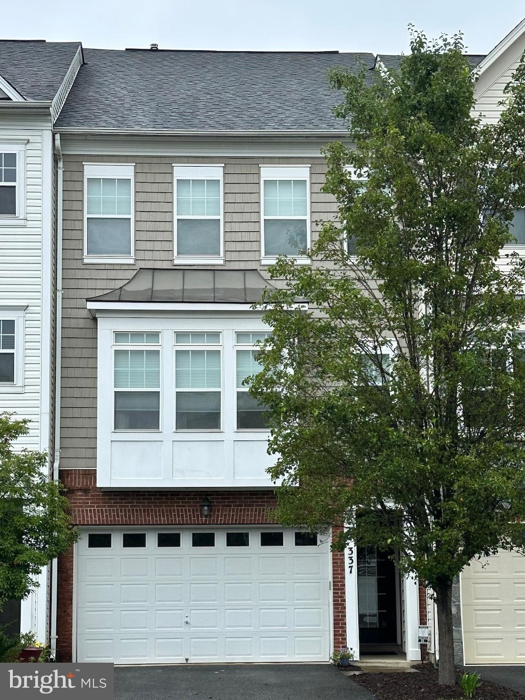337 Woodstream Blvd, Stafford, VA 22556 - view of front of home with a standing seam roof, driveway, a metal roof, and roof with shingles