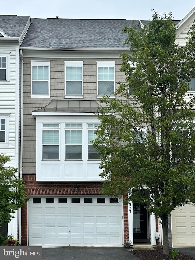 337 Woodstream Blvd, Stafford, VA 22556 - view of front of home with a standing seam roof, driveway, a metal roof, and roof with shingles