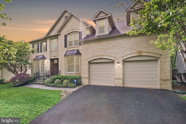 10915 Lamplighter Ln, Potomac, MD 20854 - view of front of property featuring asphalt driveway, brick siding, and a yard