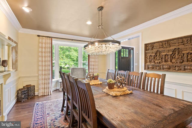 10915 Lamplighter Ln, Potomac, MD 20854 - dining space featuring a chandelier, wood finished floors, crown molding, a wainscoted wall, and a decorative wall