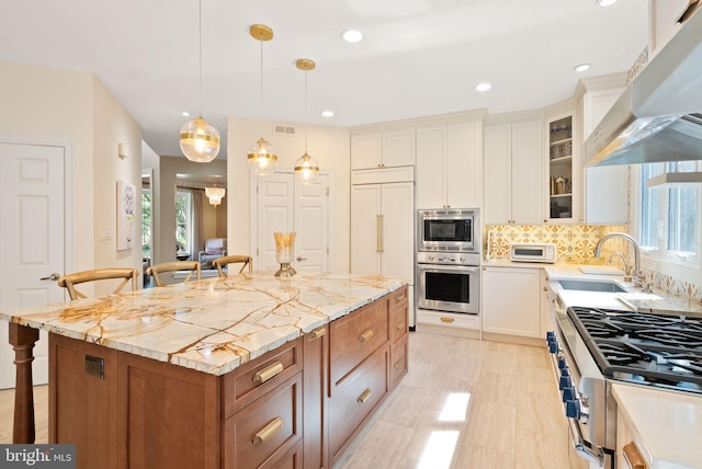 10915 Lamplighter Ln, Potomac, MD 20854 - kitchen featuring built in appliances, under cabinet range hood, a kitchen breakfast bar, tasteful backsplash, and glass insert cabinets
