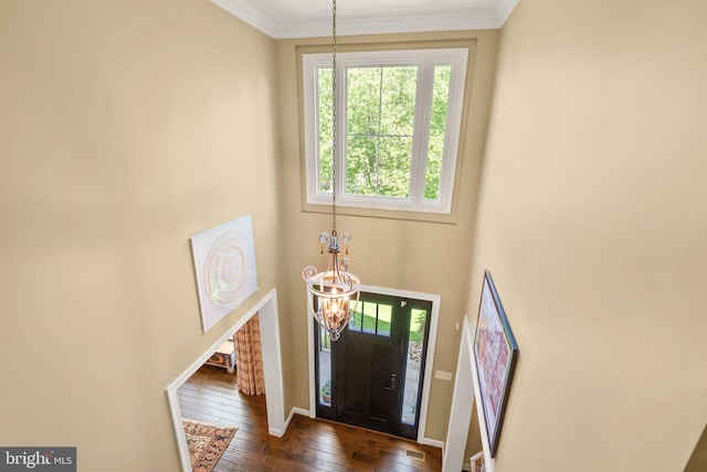 10915 Lamplighter Ln, Potomac, MD 20854 - foyer with a chandelier, dark wood finished floors, and ornamental molding