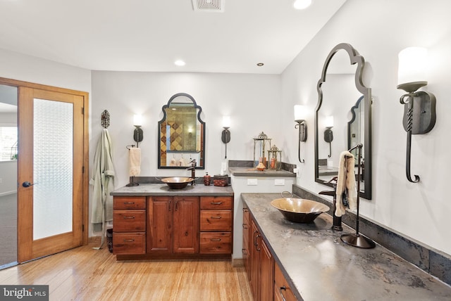 10915 Lamplighter Ln, Potomac, MD 20854 - full bath with two vanities, wood finished floors, and recessed lighting
