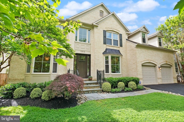 10915 Lamplighter Ln, Potomac, MD 20854 - view of front of home featuring asphalt driveway, brick siding, and a front lawn