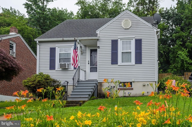 556 Hillcrest Rd, York, PA 17403 - view of front facade with cooling unit, entry steps, roof with shingles, and a front yard