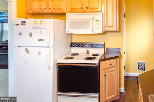 556 Hillcrest Rd, York, PA 17403 - kitchen with white appliances, dark countertops, and wood finished floors
