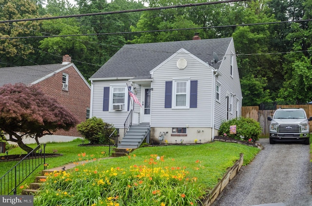 556 Hillcrest Rd, York, PA 17403 - view of front facade with entry steps, a shingled roof, a chimney, and cooling unit