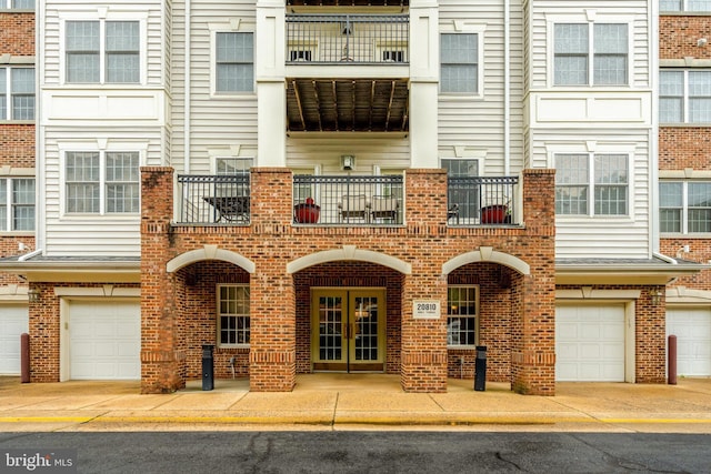 20810 Noble Ter Unit 104, Sterling, VA 20165 - view of building exterior featuring a garage and driveway