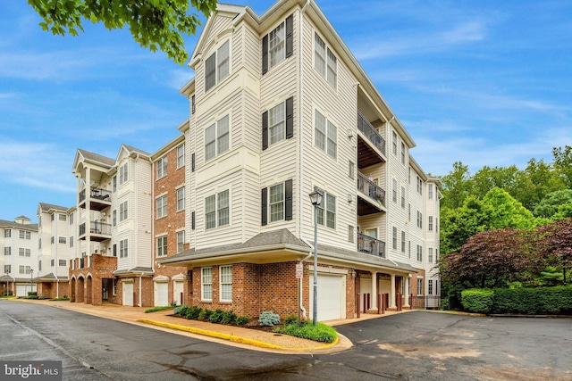20810 Noble Ter Unit 104, Sterling, VA 20165 - view of apartment building / complex featuring an attached garage