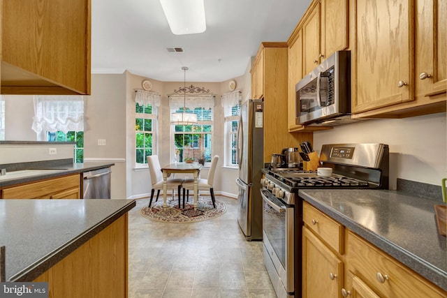 20810 Noble Ter Unit 104, Sterling, VA 20165 - kitchen featuring stainless steel appliances, dark countertops, and hanging light fixtures