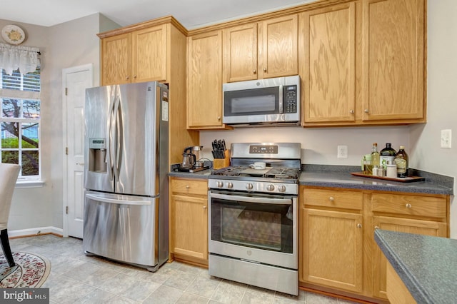 20810 Noble Ter Unit 104, Sterling, VA 20165 - kitchen with appliances with stainless steel finishes, dark countertops, and light tile patterned floors
