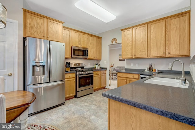 20810 Noble Ter Unit 104, Sterling, VA 20165 - kitchen featuring stainless steel appliances, dark countertops, and light brown cabinetry