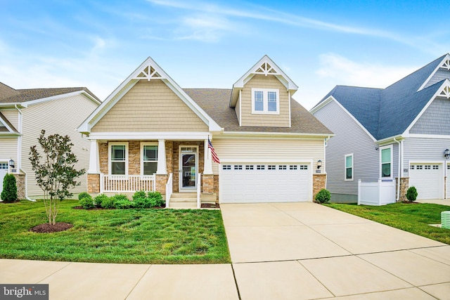 11466 Mesa Verde Ct, White Plains, MD 20695 - craftsman-style home with stone siding, a front yard, a porch, concrete driveway, and a garage