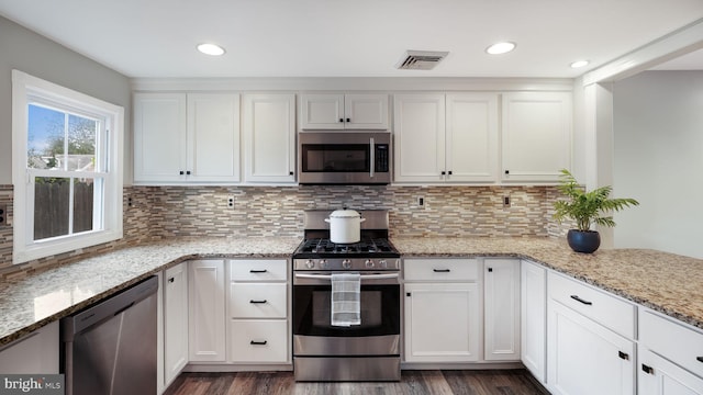 16 E Jefferson St, Newtown, PA 18940 - kitchen featuring appliances with stainless steel finishes, dark wood-style flooring, white cabinets, light stone countertops, and decorative backsplash
