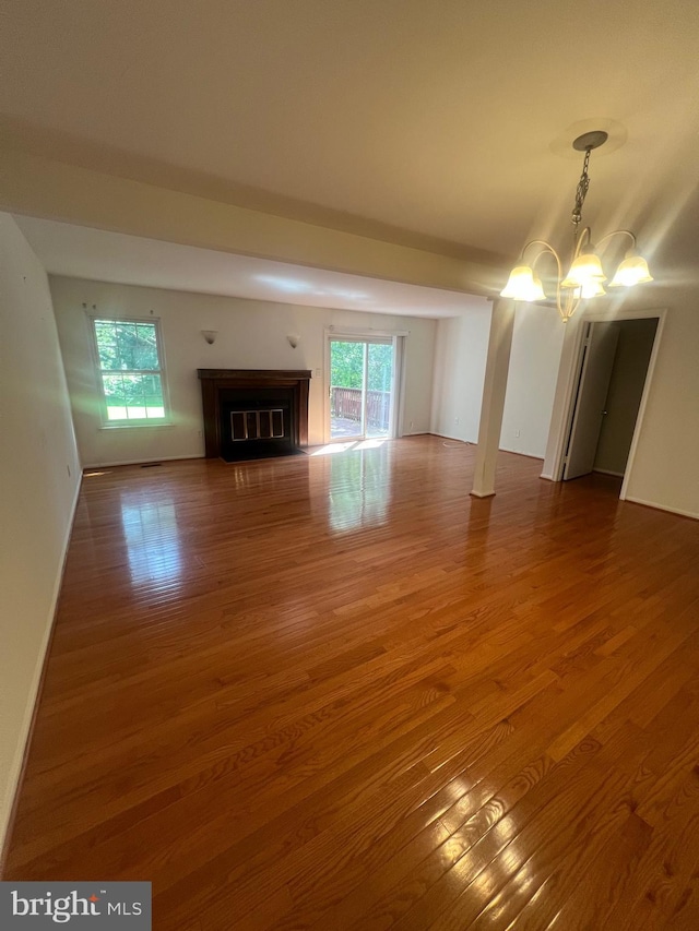11708 Lone Tree Ct, Columbia, MD 21044 - unfurnished living room featuring a chandelier, wood finished floors, and a fireplace