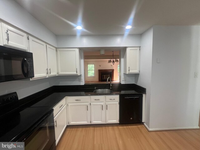 11708 Lone Tree Ct, Columbia, MD 21044 - kitchen featuring black appliances, white cabinetry, light wood finished floors, dark countertops, and recessed lighting