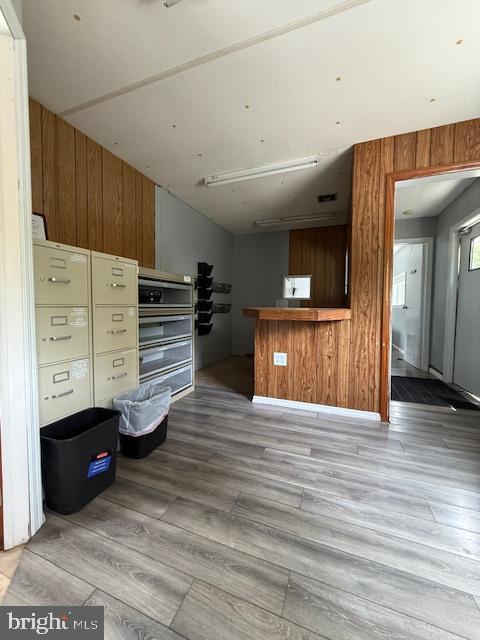 203 W Weymouth Rd, Vineland, NJ 08360 - unfurnished living room featuring light wood-style flooring and wood walls