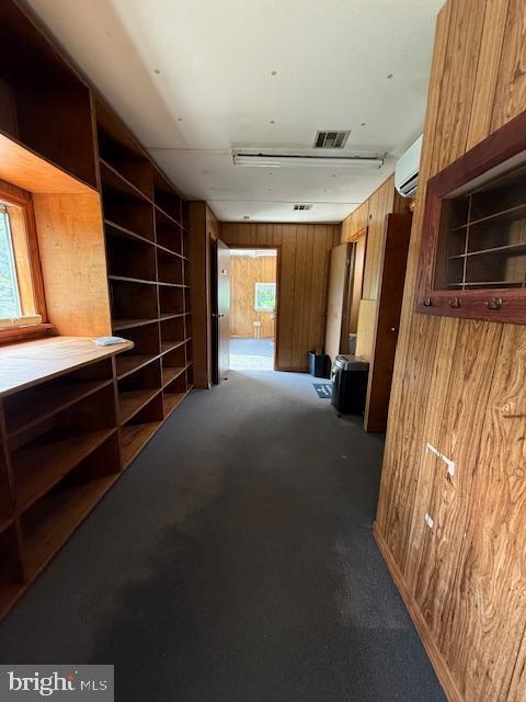 203 W Weymouth Rd, Vineland, NJ 08360 - hall featuring a wall mounted AC, wood walls, carpet flooring, and plenty of natural light