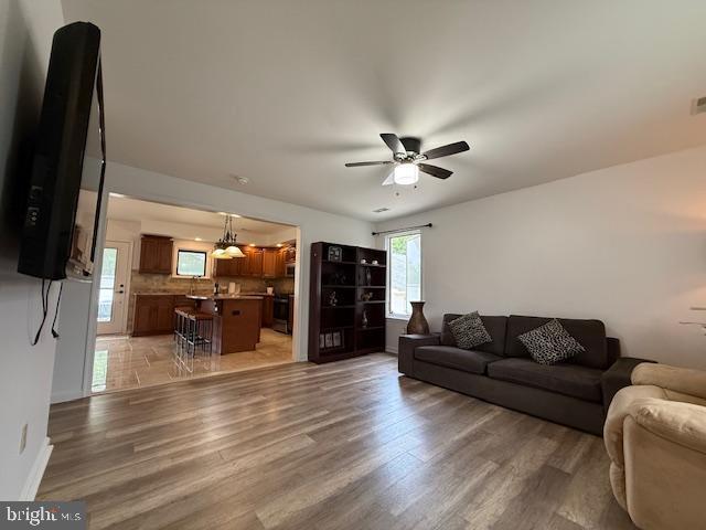 203 W Weymouth Rd, Vineland, NJ 08360 - living area with a ceiling fan, light wood finished floors, and a chandelier