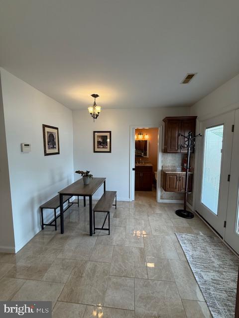 203 W Weymouth Rd, Vineland, NJ 08360 - dining room with a chandelier and baseboards