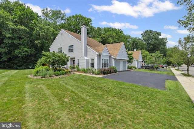 31 Magnolia Ct, Bordentown, NJ 08505 - view of front of home with a front yard, a chimney, driveway, and a garage