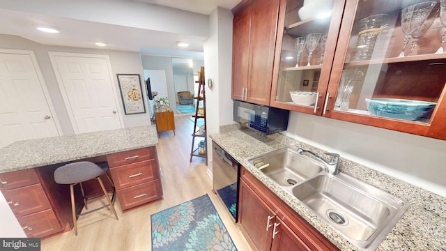 960 Fell St Unit 609, Baltimore, MD 21231 - kitchen with black appliances, light wood finished floors, glass insert cabinets, light stone counters, and recessed lighting
