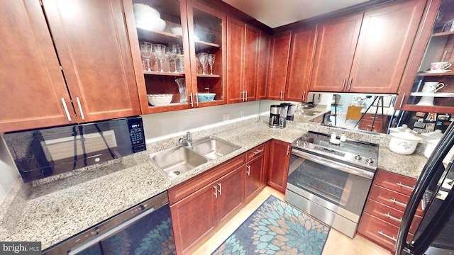 960 Fell St Unit 609, Baltimore, MD 21231 - kitchen with stainless steel range with electric cooktop, dishwasher, black microwave, light stone countertops, and open shelves