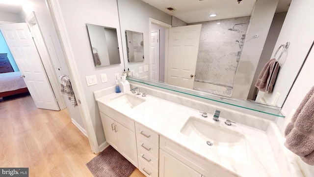 960 Fell St Unit 609, Baltimore, MD 21231 - ensuite bathroom with wood finished floors, double vanity, shower / bathtub combination, and recessed lighting