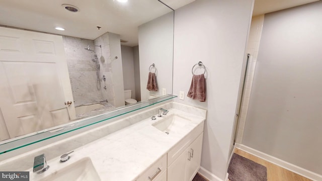 960 Fell St Unit 609, Baltimore, MD 21231 - bathroom featuring double vanity, wood finished floors, and recessed lighting