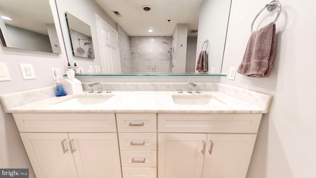 960 Fell St Unit 609, Baltimore, MD 21231 - bathroom with a tile shower, double vanity, and recessed lighting