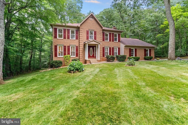 12779 Lost Creek Ct, Manassas, VA 20112 - colonial-style house with brick siding, a front lawn, and a chimney
