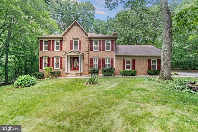 12779 Lost Creek Ct, Manassas, VA 20112 - view of front of home featuring brick siding, a chimney, and a front yard