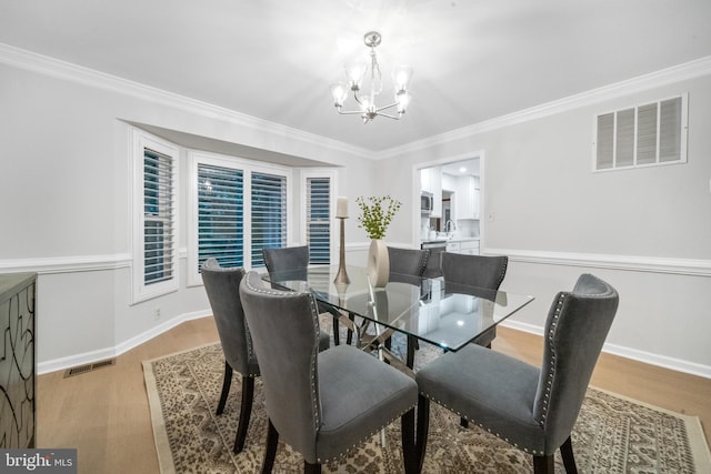 12779 Lost Creek Ct, Manassas, VA 20112 - dining space with a chandelier, wood finished floors, and ornamental molding