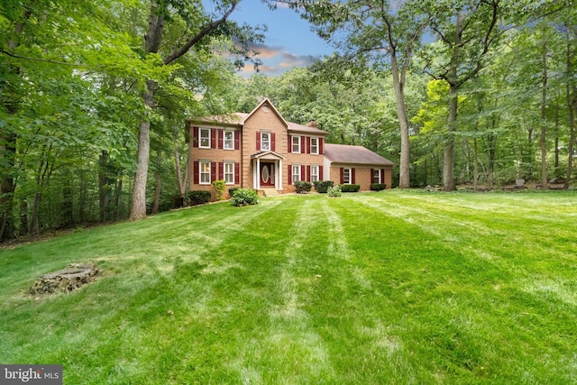 12779 Lost Creek Ct, Manassas, VA 20112 - colonial house with a front lawn, brick siding, and a chimney