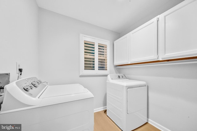12779 Lost Creek Ct, Manassas, VA 20112 - laundry area featuring washer and clothes dryer, cabinet space, and light wood-style flooring