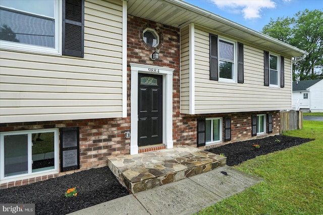 9884 Bird River Rd, Baltimore, MD 21220 - doorway to property with a lawn and brick siding