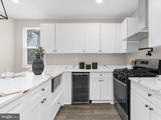 3708 Mohawk Ave, Baltimore, MD 21207 - kitchen with stainless steel appliances, wall chimney range hood, beverage cooler, dark wood finished floors, and white cabinetry