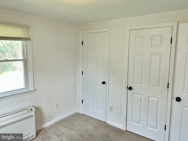 601 Mulberry St, Milton, DE 19968 - unfurnished bedroom featuring light colored carpet and a textured ceiling