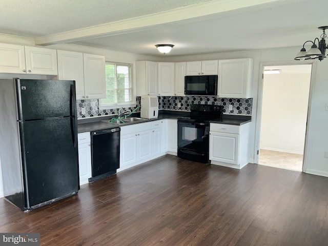 601 Mulberry St, Milton, DE 19968 - kitchen featuring black appliances, dark countertops, decorative backsplash, dark wood-type flooring, and beam ceiling