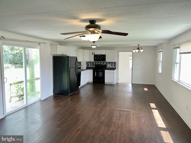 601 Mulberry St, Milton, DE 19968 - unfurnished living room featuring a chandelier, dark wood-style floors, ceiling fan, and a textured ceiling