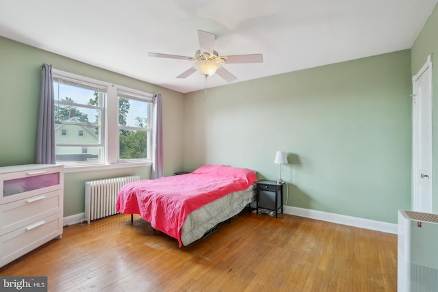 6604 Altamont Ave, Baltimore, MD 21228 - bedroom featuring radiator, light wood-type flooring, and a ceiling fan