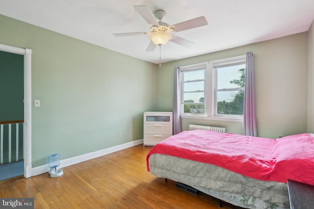 6604 Altamont Ave, Baltimore, MD 21228 - bedroom with radiator heating unit, hardwood / wood-style flooring, and a ceiling fan