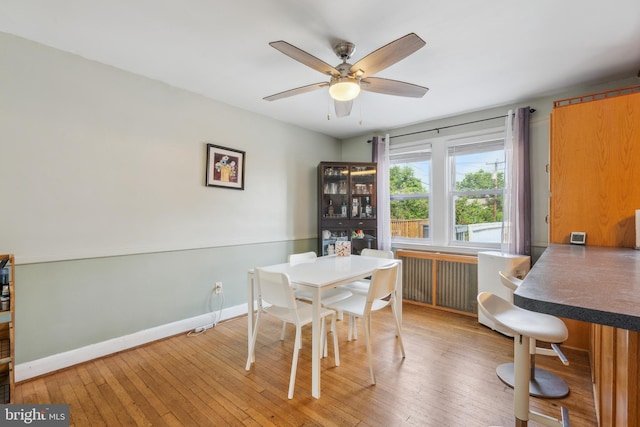 6604 Altamont Ave, Baltimore, MD 21228 - dining area with hardwood / wood-style flooring, a ceiling fan, and radiator
