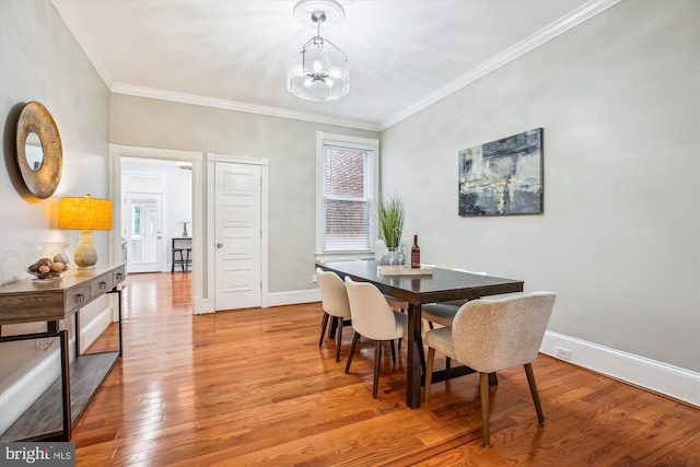 609 Elliott St NE, Washington, DC 20002 - dining area featuring ornamental molding, light wood finished floors, and a chandelier
