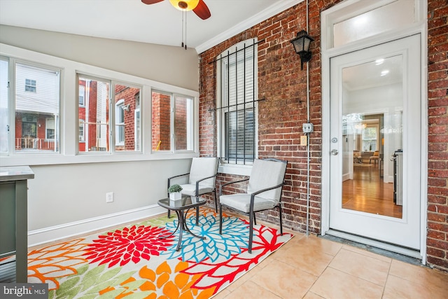 609 Elliott St NE, Washington, DC 20002 - sunroom / solarium with brick wall, tile patterned floors, crown molding, and lofted ceiling