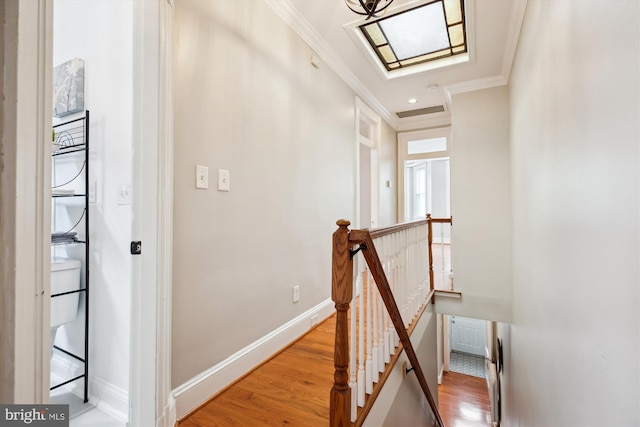 609 Elliott St NE, Washington, DC 20002 - hallway with an upstairs landing, ornamental molding, light wood finished floors, and a skylight