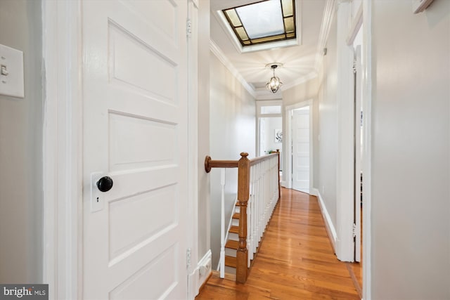 609 Elliott St NE, Washington, DC 20002 - hallway with light wood-style floors, crown molding, and an upstairs landing