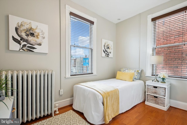 609 Elliott St NE, Washington, DC 20002 - bedroom featuring radiator and wood finished floors